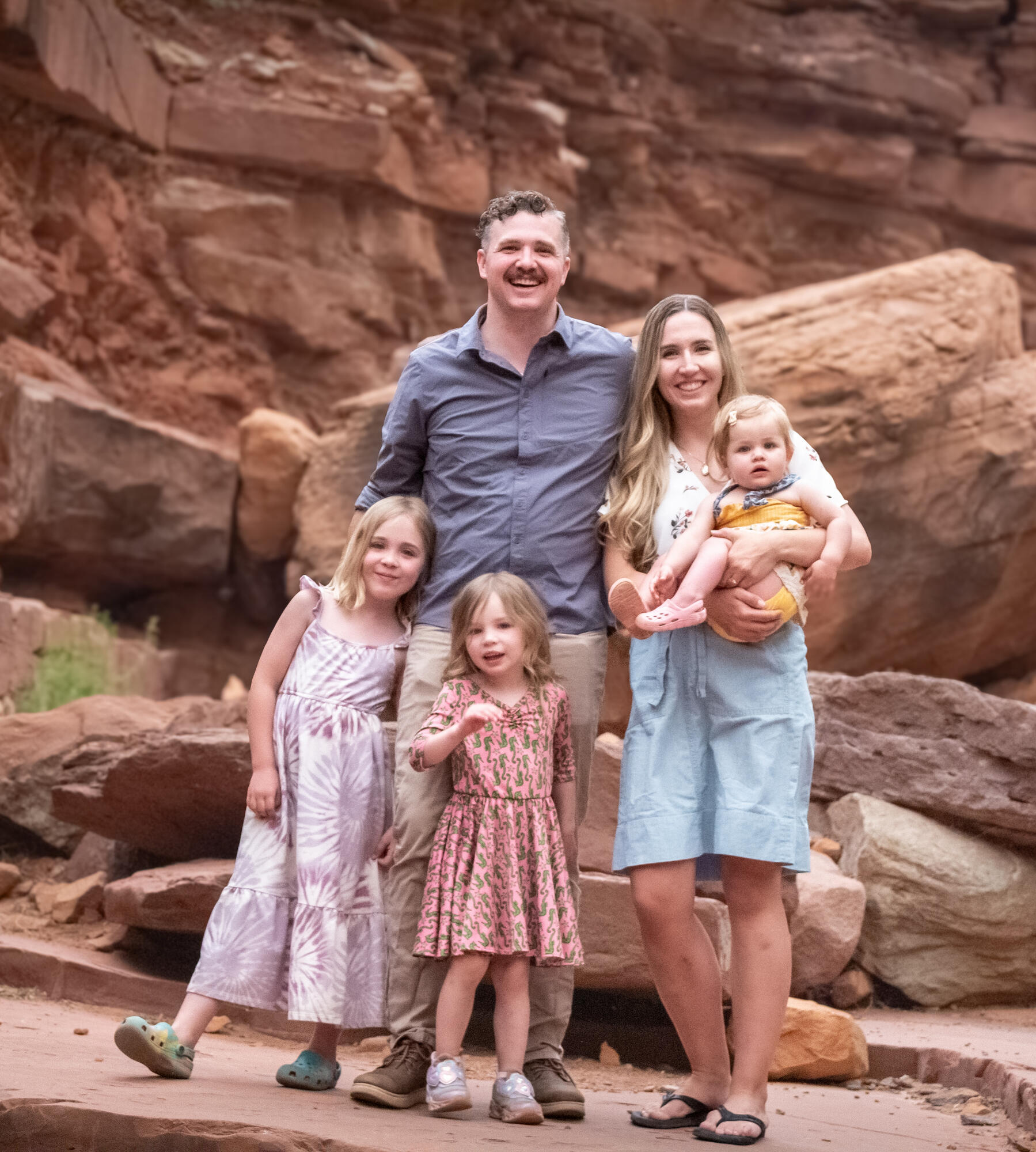 family of five in Moab canyon standing on red rocks family photos Moab red rocks